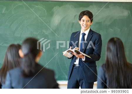Male teacher teaching in a classroom Male teacher teaching in a classroom 99393901