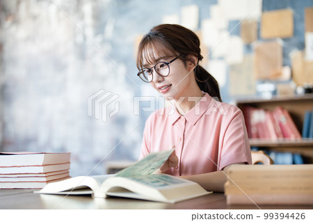 A young woman reading A young woman reading 99394426