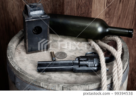 Old west revolver with cartridge and silver dollar 99394538