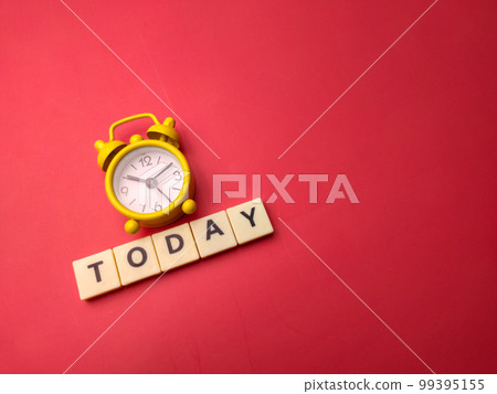 Yellow alarm clock with the word TODAY on a red background. 99395155