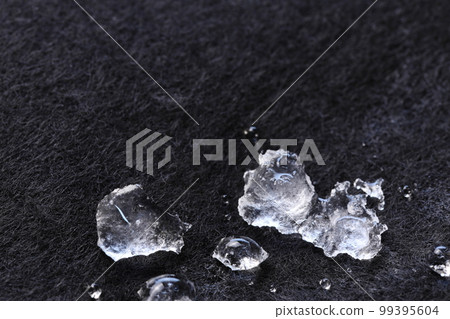 Snow ice on black felt [close-up] 99395604