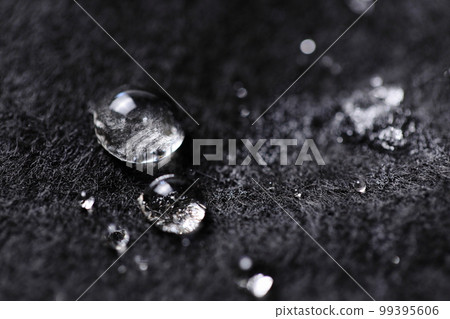 Snow ice on black felt [close-up] 99395606