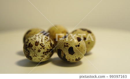 Spotted quail eggs on a light background, natural eco-friendly products. Spotted quail eggs on a light background, natural eco-friendly products. 99397163