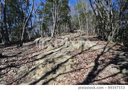 The enclosure and stone walls of Komayama Castle in Harima overlooking the city of Kamigori 99397553