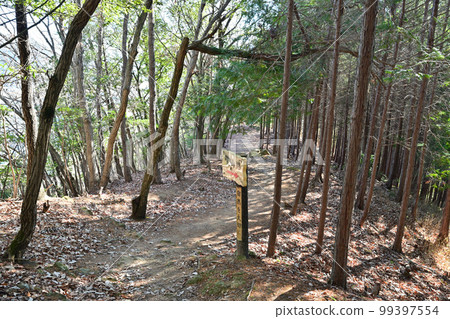 The enclosure and stone walls of Komayama Castle in Harima overlooking the city of Kamigori 99397554