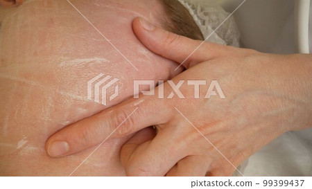 Close-up of a mature woman receiving facial cryolipolysis. Close-up of the face, lipasuction procedure. Close-up of a mature woman receiving facial cryolipolysis. Close-up of the face, lipasuction procedure. 99399437