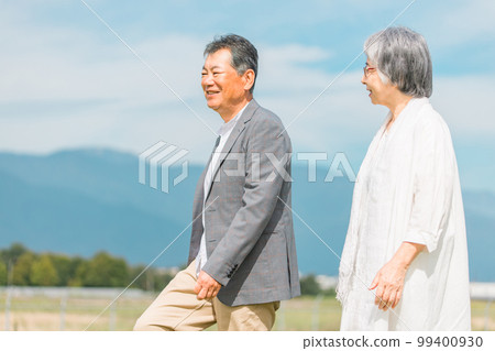 Japanese elderly couple walking while talking on the street (senior man and woman) Japanese elderly couple walking while talking on the street (senior man and woman) 99400930