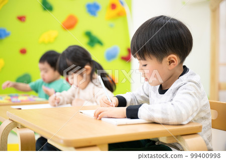 A child studying, as well as an image of an entrance exam for elementary school A child studying, as well as an image of an entrance exam for elementary school 99400998