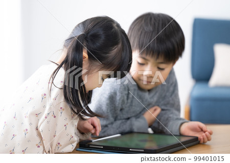 Children playing games and studying on tablets 99401015