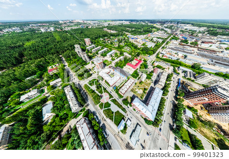 Aerial city view with crossroads and roads, houses, buildings, parks and parking lots. Sunny summer panoramic image Aerial city view with crossroads and roads, houses, buildings, parks and parking lots. Sunny summer panoramic image 99401323