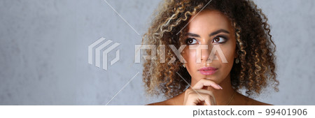 Portrait of a pensive latino woman looks up mysteriously Portrait of a pensive latino woman looks up mysteriously 99401906