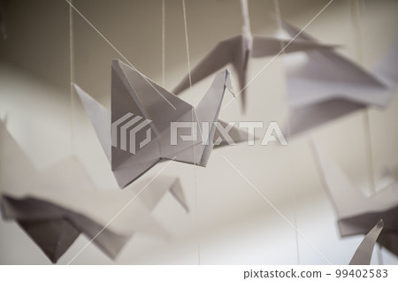 Japanese folded Origami cranes hanging on with strings. Hundreds handmade paper birds isolated with copy space. 1000 thousand crane sculpture topic. Symbol of peace, faith, health, wishes, hope Japanese folded Origami cranes hanging on with strings. Hundreds handmade paper birds isolated with copy space. 1000 thousand crane sculpture topic. Symbol of peace, faith, health, wishes, hope 99402583