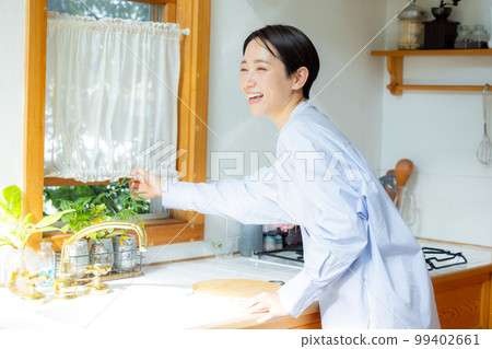 A woman who opens the window A woman who opens the window 99402661