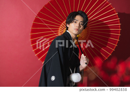 一個穿著帶徽章的袴的男人,一把日本傘 一個穿著帶徽章的袴的男人,一把日本傘 99402838