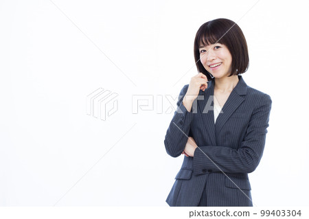 A business woman in her thirties thinking with a smile A business woman in her thirties thinking with a smile 99403304