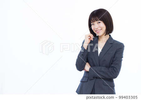 A business woman in her thirties thinking with a smile A business woman in her thirties thinking with a smile 99403305