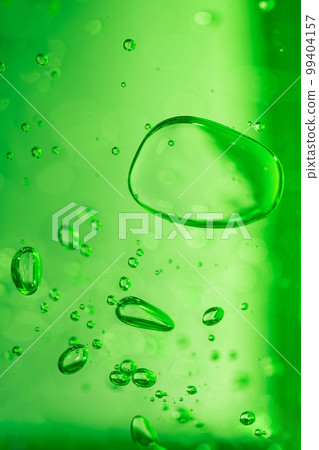 Aloe vera gel serum texture. Green cosmetic gel product with bubbles close up. 99404157