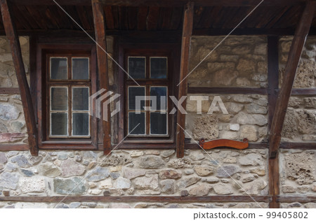 medieval windows on the stone wall. traditional old balkan architecture 99405802