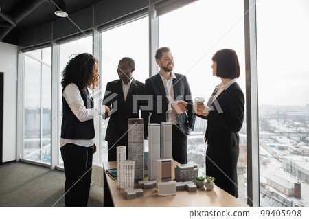 Team of diverse four multiethnic businesspeople shaking hands with each other 99405998