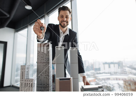 Focus on keys in hand of real estate manager homeowner businessman banker salesman Focus on keys in hand of real estate manager homeowner businessman banker salesman 99406059