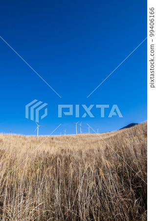 Scenery of wind power generation in the wind blowing in Aso in the white clouds and blue sky Scenery of wind power generation in the wind blowing in Aso in the white clouds and blue sky 99406166