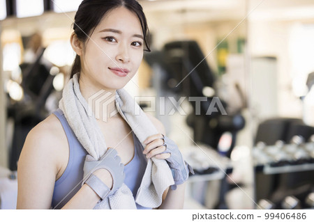 Young woman taking a break at the gym Young woman taking a break at the gym 99406486