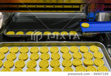 Automatic golden nut snacks production line on conveyor belt equipment machinery in factory, industrial food production. 99407189