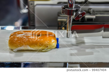 Automatic hamburger buns production line on conveyor belt equipment machinery in factory, industrial food production. Automatic hamburger buns production line on conveyor belt equipment machinery in factory, industrial food production. 99407404