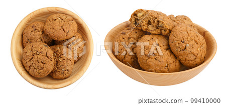 oatmeal cookies with flax, pumpkin and sunflower seeds in wooden bowl with full depth of field. Top view. Flat lay oatmeal cookies with flax, pumpkin and sunflower seeds in wooden bowl with full depth of field. Top view. Flat lay 99410000