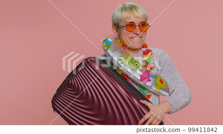 Traveler tourist woman holding luggage, swimming ring, summer vacation, journey, trip to seaside Traveler tourist woman holding luggage, swimming ring, summer vacation, journey, trip to seaside 99411842
