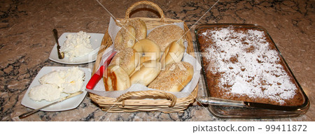 Bagels and coffee cack set up for brunch on a kitchen counter Bagels and coffee cack set up for brunch on a kitchen counter 99411872