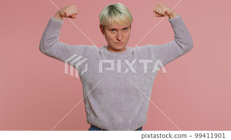 Woman showing biceps and looking confident, feeling power strength to fight for rights, success win 99411901