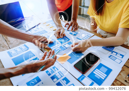 UX developer and ui designer brainstorming about mobile app interface wireframe design with customer breif and color code at modern office.. 99412076