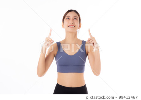 Portrait of beautiful young asian woman in sportwear smile and presenting isolated. 99412467