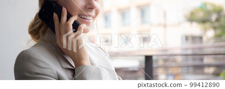 Beautiful young caucasian businesswoman sitting and talking on smartphone with relax. Beautiful young caucasian businesswoman sitting and talking on smartphone with relax. 99412890