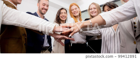 Group of business team harmonious with man and woman joining hands stack together. Group of business team harmonious with man and woman joining hands stack together. 99412891