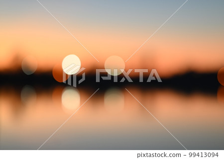 Evening mood besides a river against a blurred background 99413094