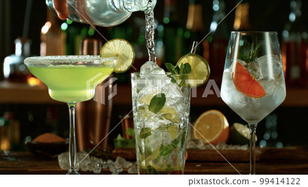 Fresh various cocktails on the bar, dark toned background Fresh various cocktails on the bar, dark toned background 99414122