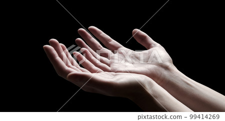 The outstretched hands of a praying man 99414269