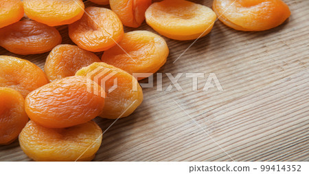 Dried fruits on a wooden table 99414352