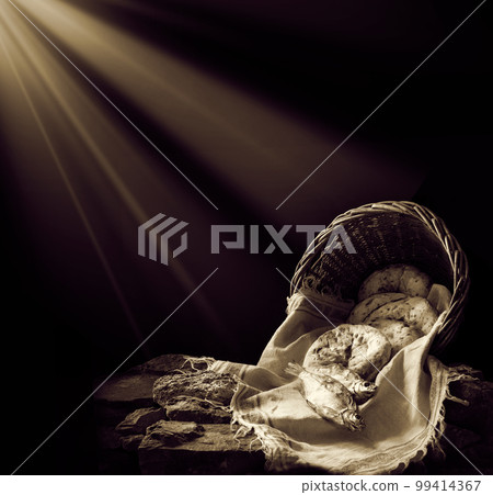 Five loaves and two fish in a basket 99414367