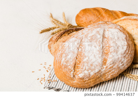 Homemade natural breads. Different kinds of fresh bread as background, perspective view with copy space 99414637