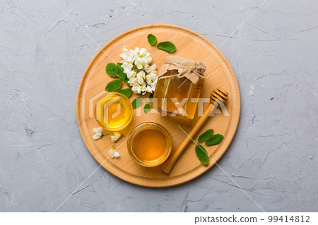 honey jar with acacia flowers and leaves. fresh honey top view flat lay honey jar with acacia flowers and leaves. fresh honey top view flat lay 99414812