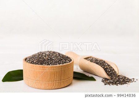 Chia seeds in bowl and spoon on colored background. Healthy Salvia hispanica in small bowl. Healthy superfood 99414836