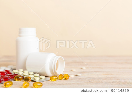Medicine for treatment HIV infection. Pills and capsules and battle on the table. Different colorful tablets at colored background with copy space 99414859