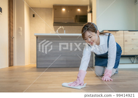 Housekeeper, housekeeping agent, young woman mopping the floor Housekeeper, housekeeping agent, young woman mopping the floor 99414921