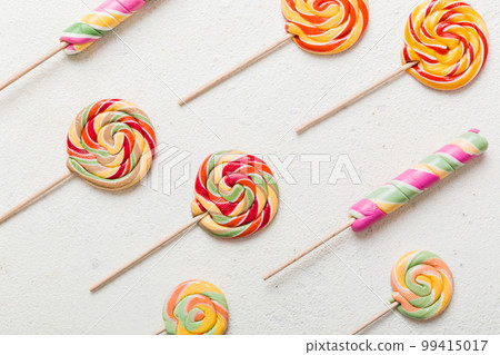 Set of colorful lollipops on colored background. Summer concept. Party Happy Birthday or Minimalist Concept Set of colorful lollipops on colored background. Summer concept. Party Happy Birthday or Minimalist Concept 99415017
