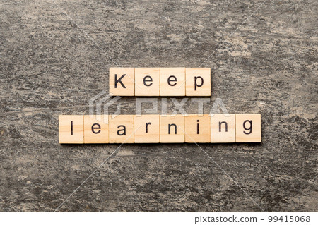 keep learning word written on wood block. keep learning text on table, concept 99415068