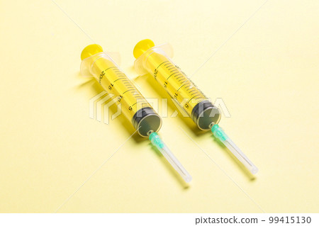 Top view of different syringes for injection on colorful background. Medical equipment concept with copy space Top view of different syringes for injection on colorful background. Medical equipment concept with copy space 99415130