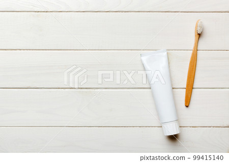 toothpaste and toothbrush top view with copy space on colored background. Flat lay. Dental hygiene. Oral care products on light background. Body care concept 99415140